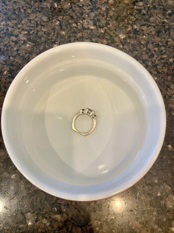 Ring being cleaned in a small dish of club soda